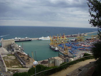 High angle view of city by sea against sky