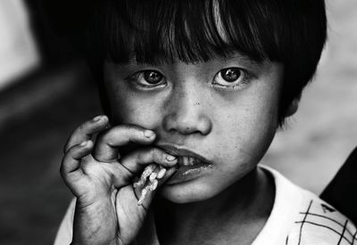 Close-up portrait of boy eating food