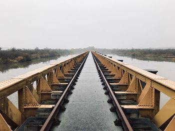 View of wooden bridge against clear sky