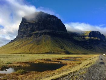 Scenic view of mountains against cloudy sky