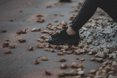 Low section of woman on sand at beach