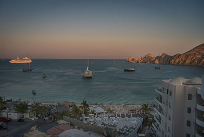 High angle view of sea and buildings against clear sky