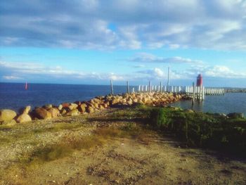 Scenic view of sea against cloudy sky