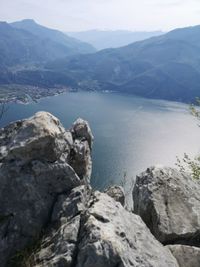 Scenic view of sea and mountains against sky