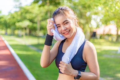 Portrait of smiling young woman using mobile phone