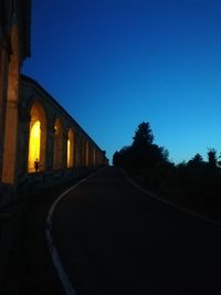 Low angle view of road against clear blue sky