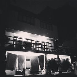 Low angle view of illuminated building against sky at night