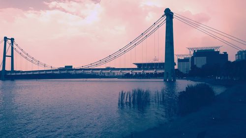 View of suspension bridge against cloudy sky