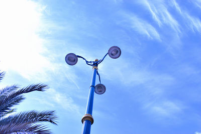 Low angle view of street light against blue sky