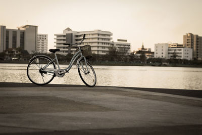 Bicycle on street against buildings in city