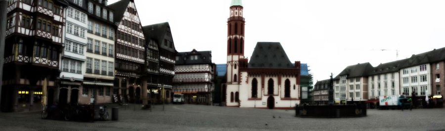 Panoramic view of city street against sky