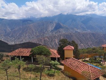 Houses and mountains against sky