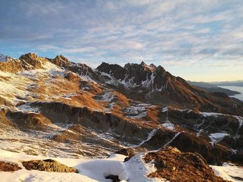 Scenic view of snowcapped mountains against sky during sunset