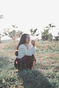 Woman sitting on field