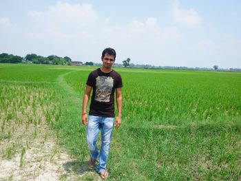 Portrait of man standing on field