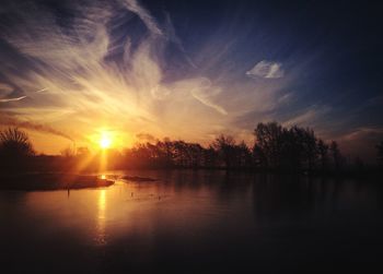 Scenic view of lake against sky during sunset