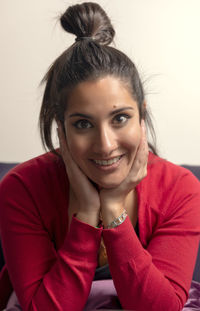 Portrait of beautiful young woman sitting at home