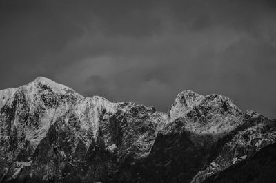 Low angle view of snowcapped mountain range in tuscany called apuan alps against sky