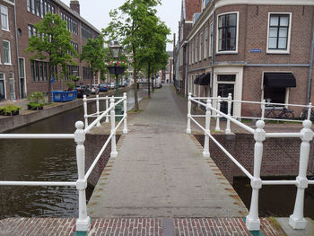 View of footpath amidst buildings