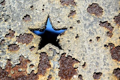 Full frame shot of weathered wall with star