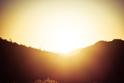 Scenic view of silhouette mountains against sky during sunset