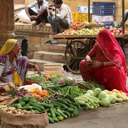 Man and vegetables for sale in market