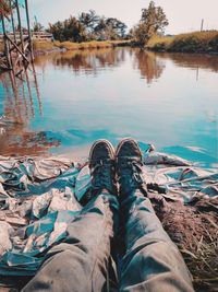 Low section of person relaxing in lake