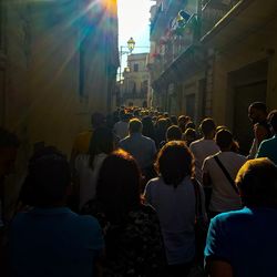 Crowd in city against sky