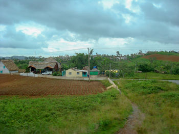 Houses on field against sky