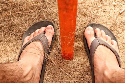 Low section of man wearing shoes