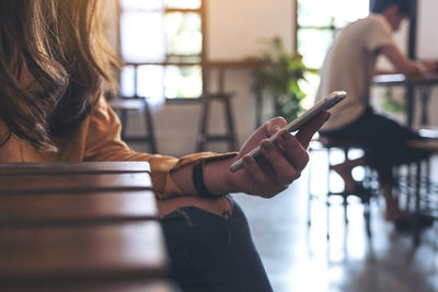 Midsection of woman using mobile phone