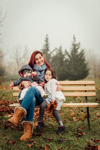 Portrait of happy woman sitting on bench