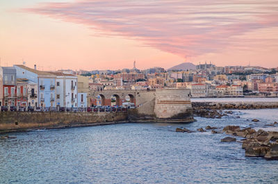 Buildings in city at sunset