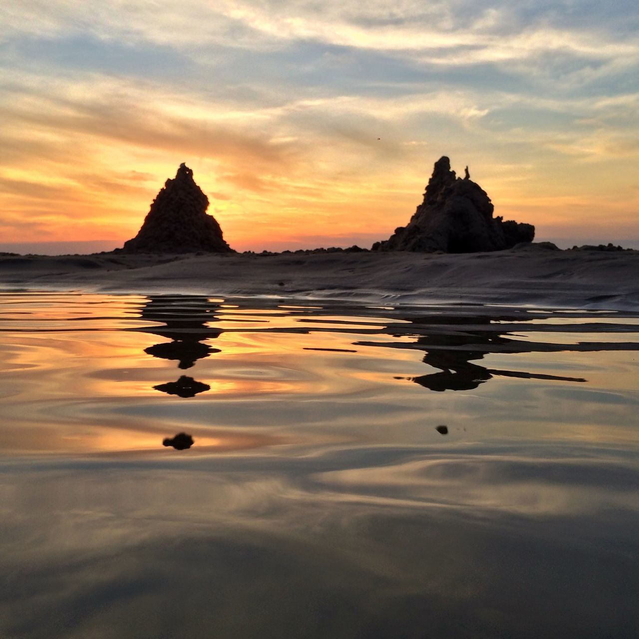 sunset, water, tranquil scene, scenics, sea, tranquility, sky, beauty in nature, reflection, beach, orange color, idyllic, nature, rock - object, horizon over water, rock formation, waterfront, shore, cloud - sky, majestic