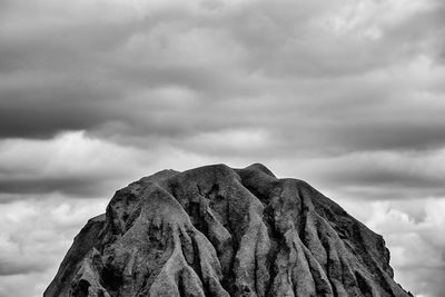 Low angle view of rock formation against sky