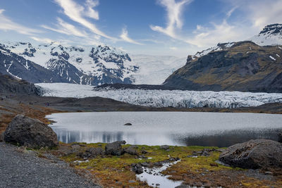 Beautiful view of glacial lake against snowcapped mountains in volcanic valley