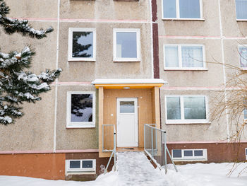 Modern apartment building with colorful facades on the outskirts of winter city. residential complex