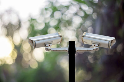 Close-up of security cameras on metallic pole