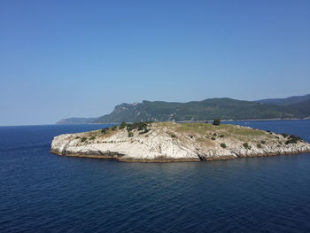 Scenic view of sea against clear blue sky