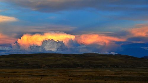 Scenic view of landscape against cloudy sky