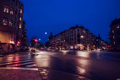 Illuminated city street and buildings at night