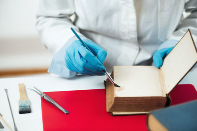 Old book repair in restoration laboratory