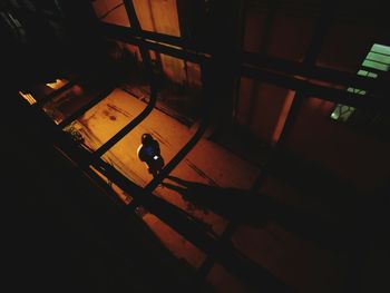 Rear view of a silhouette man walking in the dark