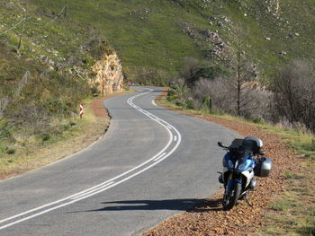 View of people riding motorcycle on road