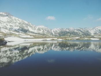 Scenic view of snow covered mountains against sky