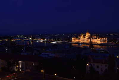 High angle view of buildings lit up at night