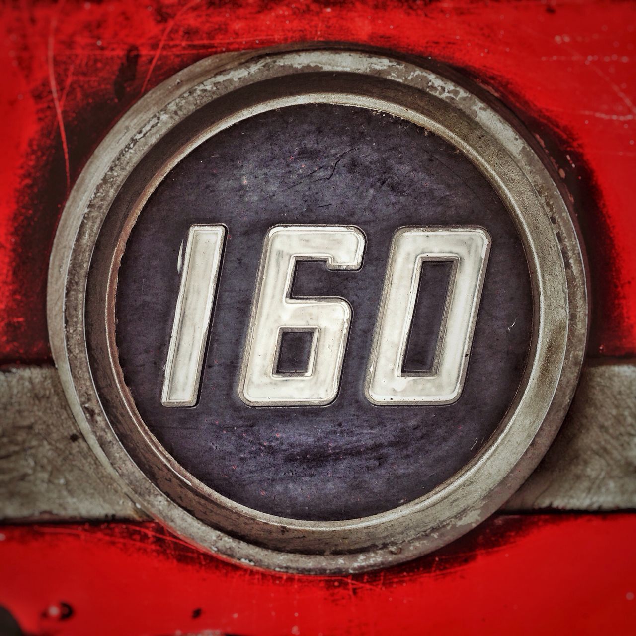 red, circle, close-up, communication, geometric shape, number, text, no people, metal, wall - building feature, white color, day, full frame, outdoors, shape, part of, textured, western script, pattern, brick wall