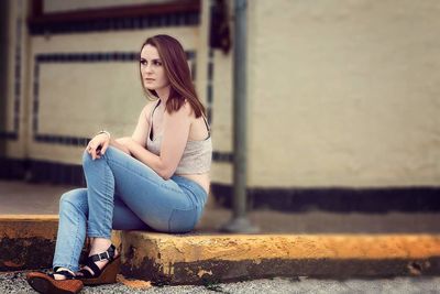 Portrait of young woman sitting outdoors