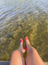 Low section of woman legs in water