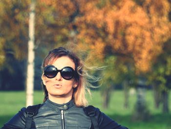 Portrait of woman wearing sunglasses standing outdoors